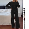Close-up of black knit lounge set featuring buttoned cardigan and wide-leg pants - S / Black