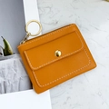 Yellow PU leather mini coin purse with metal zipper and keychain on marble background - Tan