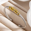 Two-tone silver twisted cable open bangle with five gold spiral ring accents - Two-tone (Gold & Silver)