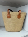 Light brown woven straw tote bag featuring brown leather handles and white stitching details - Solid Khaki