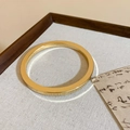 Minimalist gold bangle with flat rectangular profile on elegant calligraphy backdrop - Gold