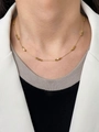 Close-up of minimalist 18K gold-plated beaded chain necklace worn on a female model - Gold