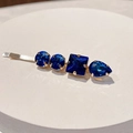Detailed macro of gold hair clip featuring prong-set deep blue multifaceted rhinestones - Style E (Deep Blue)
