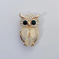 Golden owl brooch with sparkling rhinestones and teardrop gemstones on white background - Gold Owl