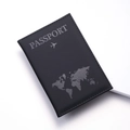 Close-up of black matte PU leather passport cover with world map and aircraft pattern - Black