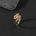 Macro shot of gold-plated fish ring with zircon paving and blue evil eye enamel details - I-Twin Fish Evil Eye