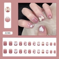 Détail de faux ongles dégradés roses avec nœuds 3D, perles et motifs de cœurs blancs - Style Cœur Papillon (Z246)