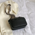 Black litchi-grain crossbody bag with a stylish striped woven strap and silver buckle - Black