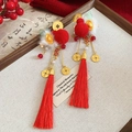 Detail of New Year hair clips with red pompoms, lucky koi tassels and golden accents - Red and Gold Ingot Tassel Style