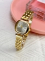 Elegant ladies quartz watch with gold metal strap and square silver dial on a pink tray - Gold Case White Dial