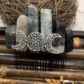 Macro shot of handmade crystal hair comb with silver Triple Goddess symbol and moon motifs - Black Rutilated Quartz Black Wire Silver Moon