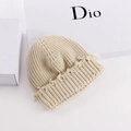Detailed close-up of cream chunky knit beanie featuring trendy distressed fringe edges - Beige