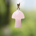 Pink rose quartz mushroom pendant with silver clasp in a natural forest setting - Rose Quartz