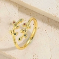 Detail view of a vintage gold leaf ring with colorful zircons on a natural stone base - Red Green Blue Colorful Leaf Style