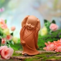 Cute nodding monk car ornament in orange robes smiling on a natural moss background - Hands Up Pose (Small Size)