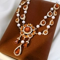 Detail of vintage gold necklace with amber gems and pearls on a velvet stand - Clavicle Necklace-Gold Coffee
