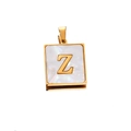 Close-up of golden square pendant with white shell inlay featuring letter Z engraving - Gold Z