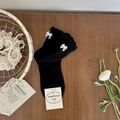Black cotton crew socks with white organza bow and ruffled cuffs on wooden desk - One Size / Black