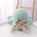 Detailed view of mint green straw hat featuring floral bow and delicate lace brim edges - Kids (52-54cm) / Mint Green Hat