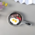3D resin food fridge magnet featuring a miniature silver pan with double fried eggs and bacon - New Frying Pan