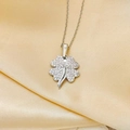 Sparkling silver four-leaf clover necklace with cubic zirconia on champagne silk background - Silver