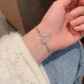 Detail of moon and star charm bracelet with sparkling cubic zirconia on a wrist - S548 Silver