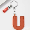 Detail of orange PU leather letter U keychain featuring tassel and silver metal ring - Orange-Letter U