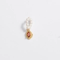 Macro detail of golden irregular frame with orange gem and white pearl accent - Pendant-Ruby Red Gem
