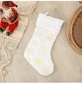 Close-up of white plush Christmas stocking with golden snowflake sequins on wood floor - Gold Stamping Snowflake Style