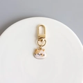 Cute enamel orange and white cat keychain with gold finish on a minimalist plate - Orange Cat
