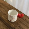 Minimalist white ceramic mug featuring red heart patterns and a unique heart-shaped handle - Heart Pattern Heart Handle