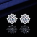 Macro shot of silver snowflake stud earrings featuring round cut stones on silk - Sunflower Stud Earrings (TZ1)