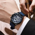 Men's blue silicone sports quartz watch with calendar worn in a business office setting - Blue Strap Black Case