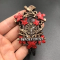 Handheld resin Black Forest cuckoo clock magnet with red maple leaves and bird detail - Black Forest Cuckoo Clock
