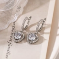 Macro view of silver heart earrings with sparkling cubic zirconia and intricate metalwork - Silver (44079)