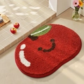 Plush red apple-shaped bathroom rug with smiley face and green leaf detail - Happy Little Apple