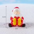 Miniature sitting Santa Claus resin figurine holding gift box, height 3.2cm, width 3cm - Santa Claus with Gift Box