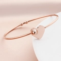 Rose gold minimalist open bangle featuring a hollow heart pendant with a metal bead - Rose Gold