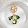 Detail of panda bamboo pendants with gold plating and green enamel on white ceramic - Panda with Bamboo V3