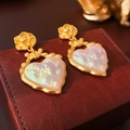 Detail of vintage heart earrings with gold rose pattern on deep red leather box - Silver Earring Post Resin Heart Flower Earrings