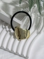 Detailed view of an irregular gold metal piece on a black elastic ponytail holder - Style 4 (Gold Lava Irregular Sheet)