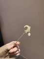 Golden crescent moon hair pin with white pearl tassel in a vintage retro style - Moon