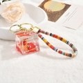 Capybara acrylic liquid keychain featuring red background with white pearls and woven strap - Capybara Quicksand (Lanyard Style) / Square Bottle