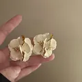 Detailed close-up of cream resin flower earrings with gold accents and 3D petal texture - 12# Cream White Enamel Flower (925 Sterling Silver Earring Post)