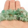 Macro shot of natural green agate tumbled stones for DIY jewelry making and necklaces - Green Aventurine Chips
