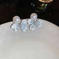 Detail view of silver flower stud earrings with faux pearls and zircons on white porcelain - Bowknot Pearl Crystal Dangle (12#银针)