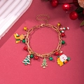 Detailed shot of Christmas charm bracelet with enamel Santa, tree and bell on red background - D1146 (Gold Christmas Tree Style)