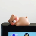Miniature light brown lazy bear ornament placed on a black monitor screen edge - Type G Lying Bear