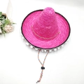 Detailansicht eines pinken mexikanischen Strohhuts mit weißen Pompons und bunter Kordel. - L (58-60cm) / Durchmesser 35cm / Rosarot