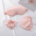 Pink satin sleep set with eye mask, scrunchie and drawstring bag on silk background - Gold Pink